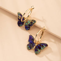Schmetterlingsohrringe aus Acryl in Gold – Blau